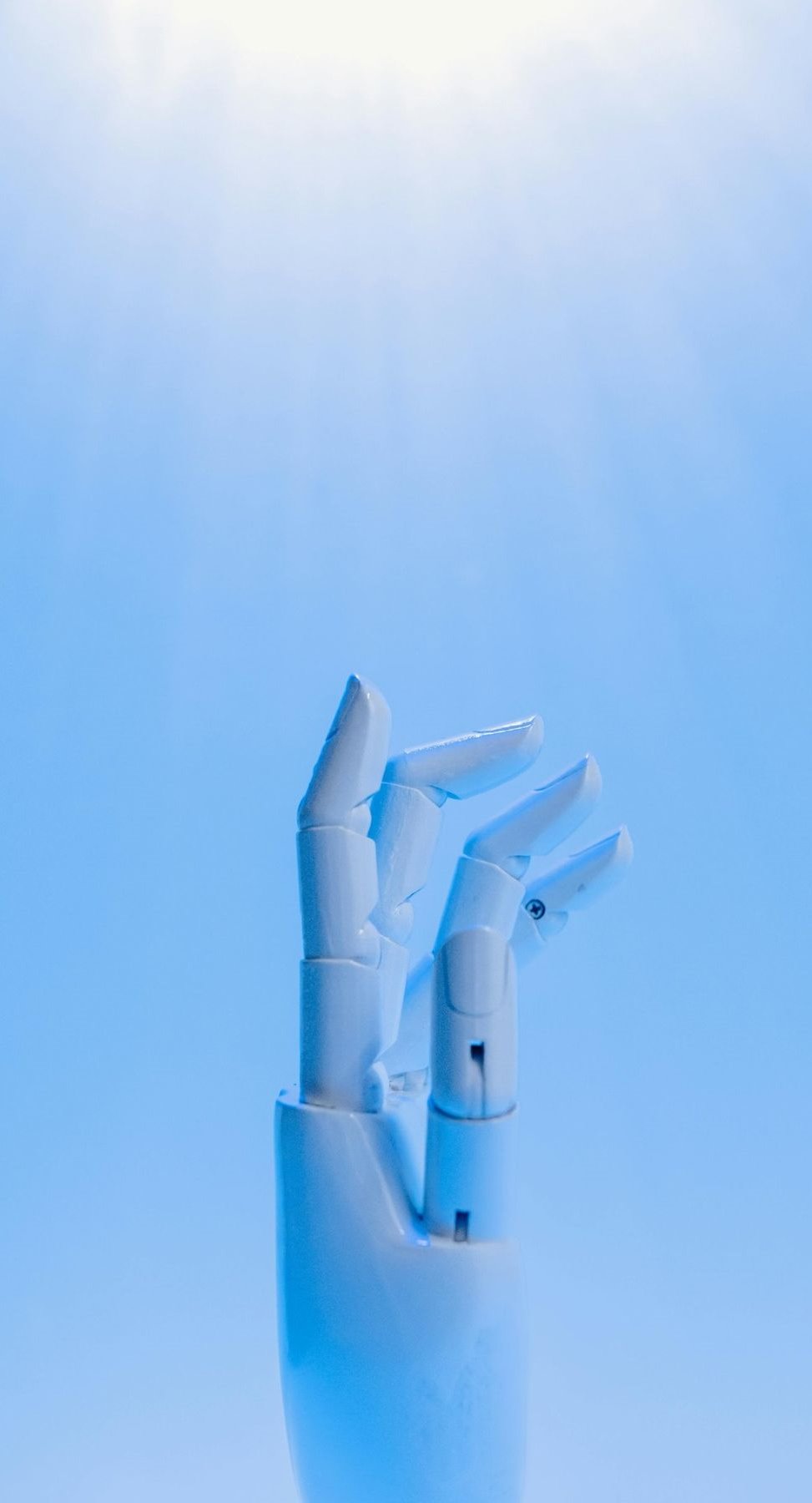 Robotic hand reaching towards sky, representing AI innovation